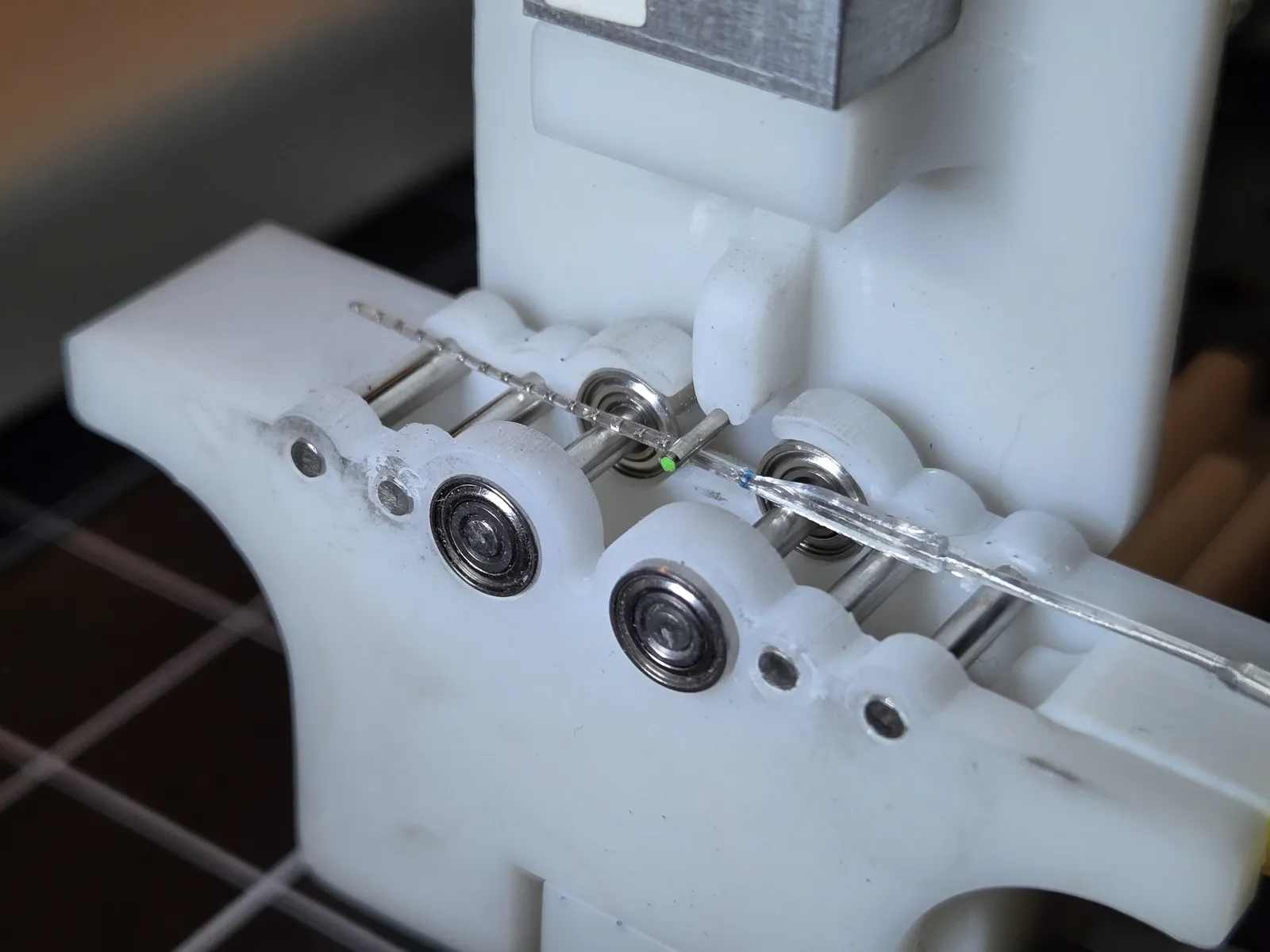 A flexible FlexDetect probe threaded between the bearings of a three-point bend fixture, bowing under load.